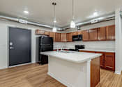 Thumbnail 29 of 35 - A kitchen with a white counter top at Melbourne Apartments, Des Moines, IA,  50320