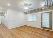 Thumbnail 15 of 35 - A room with a ceiling fan and wooden flooring at Melbourne Apartments, Des Moines, IA,  50320