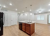Thumbnail 28 of 35 - A kitchen with a sink and a refrigerator at Melbourne Apartments, Iowa, 50320