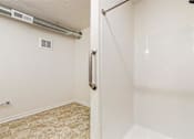 Thumbnail 35 of 35 - A bathroom with a walk-in shower and a tiled floor at Melbourne Apartments, Iowa, 50320