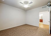 Thumbnail 13 of 35 - A room with a ceiling fan at Melbourne Apartments, Des Moines