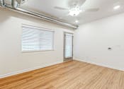 Thumbnail 32 of 35 - A room with a ceiling fan and a door at Melbourne Apartments, Des Moines, Iowa