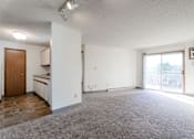 Thumbnail 42 of 90 - A spacious living room with a kitchen area in the background at Rosemont Place Apartments, Des Moines, IA