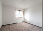Thumbnail 36 of 90 - A room with a window and carpeted floor at Rosemont Place Apartments, Iowa, 50320