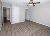Thumbnail 5 of 90 - A room with a ceiling fan and carpeted floor at Rosemont Place Apartments, Iowa