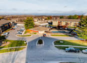 Thumbnail 72 of 90 - A parking lot with cars and apartment buildings in the background. at Rosemont Place Apartments, Iowa