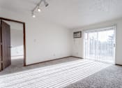 Thumbnail 29 of 90 - A room with a carpeted floor and a sliding glass door at Rosemont Place Apartments, Des Moines, IA