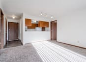 Thumbnail 23 of 90 - A room with a white wall and a brown door at Rosemont Place Apartments, Iowa