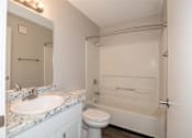 Thumbnail 15 of 90 - A white bathroom with a sink, toilet, and bathtub. at Rosemont Place Apartments, Des Moines, 50320