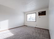 Thumbnail 24 of 90 - A room with a window and a radiator on the wall at Rosemont Place Apartments, Des Moines