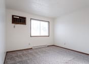 Thumbnail 20 of 90 - A room with a window and a carpeted floor. at Rosemont Place Apartments, Des Moines