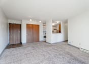 Thumbnail 40 of 90 - A spacious living room with a carpeted floor and white walls. at Rosemont Place Apartments, Des Moines, Iowa