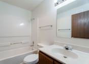 Thumbnail 34 of 90 - A white bathroom with a toilet, sink, and bathtub. at Rosemont Place Apartments, Iowa