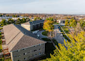 Thumbnail 70 of 90 - A view of a building with a parking lot in front of it. at Rosemont Place Apartments, Des Moines, 50320