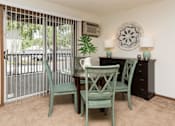Thumbnail 11 of 90 - a dining room with a table and chairs and a balcony at Rosemont Place Apartments, Iowa
