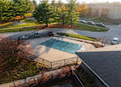 Thumbnail 43 of 90 - A swimming pool surrounded by a fence and trees. at Rosemont Place Apartments, Des Moines, IA