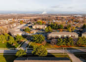 Thumbnail 54 of 90 - A view of a school from above with a road running through it. at Rosemont Place Apartments, Des Moines, Iowa