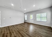 Thumbnail 6 of 30 - the living room of a new home with white walls and wood floors at Soll, Des Moines, IA 50312  