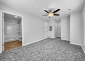 Thumbnail 18 of 30 - an empty living room with a ceiling fan and a bathroom at Soll, Des Moines, IA  