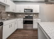 Thumbnail 10 of 30 - a kitchen with white cabinets and stainless steel appliances at Soll, Iowa, 50312