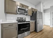 Thumbnail 5 of 30 - a kitchen with stainless steel appliances and a refrigerator at Soll, Des Moines, 50312  