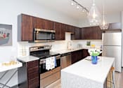 Thumbnail 8 of 30 - a kitchen with stainless steel appliances and a white counter top at Soll, Des Moines, IA 50312  
