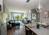 Thumbnail 7 of 30 - a living room with a kitchen and a dining table at Soll, Des Moines, IA  