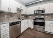 Thumbnail 11 of 30 - a kitchen with white cabinets and stainless steel appliances at Soll, Des Moines, 50312  