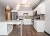 Thumbnail 12 of 30 - a white kitchen with white cabinets and stainless steel appliances at Soll, Des Moines Iowa   