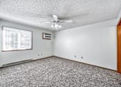 Thumbnail 13 of 21 - A room with a ceiling fan and a window with blinds at Somerset Apartments, Iowa
