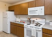 Thumbnail 19 of 21 - a kitchen with a stove microwave and refrigerator at Somerset Apartments, Des Moines, IA