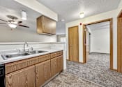 Thumbnail 9 of 21 - a kitchen with a sink and a ceiling fan at Somerset Apartments, Des Moines, 50315