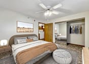Thumbnail 3 of 21 - a bedroom with a bed and a ceiling fan at Somerset Apartments, Des Moines, Iowa