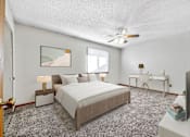 Thumbnail 6 of 21 - a bedroom with a large bed and a ceiling fan at Somerset Apartments, Des Moines