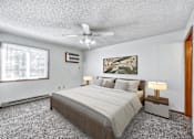 Thumbnail 8 of 21 - a bedroom with a large bed and a ceiling fan at Somerset Apartments, Iowa, 50315