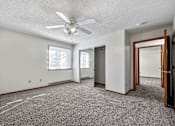 Thumbnail 12 of 21 - an empty living room with a ceiling fan at Somerset Apartments, Des Moines, IA, 50315