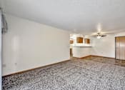 Thumbnail 7 of 21 - A spacious room with a ceiling fan and a door on the right side at Somerset Apartments, Des Moines, IA