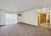 Thumbnail 10 of 21 - A room with a carpeted floor and a window with blinds at Somerset Apartments, Des Moines, 50315