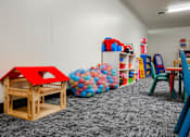 Thumbnail 23 of 26 - a play room with toys and chairs and a table with chairs at Sutton Hill Apartments, Des Moines, 50320