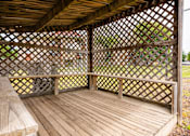 Thumbnail 20 of 26 - a gazebo with a wooden deck and a bench at Sutton Hill Apartments, IOWA, 50320