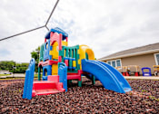 Thumbnail 21 of 26 - a multicolored play set in a yard at Sutton Hill Apartments, Des Moines, 50320