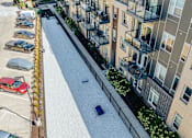 Thumbnail 25 of 40 - an aerial view of an apartment complex with cars parked in the street at Velocity Apartments, IA, 50309 