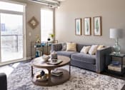 Thumbnail 1 of 40 - a living room with a couch and a coffee table at Velocity Apartments, Des Moines