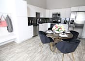 Thumbnail 4 of 40 - A kitchen with a table and chairs in the middle at Velocity Apartments, Iowa, 50309