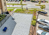 Thumbnail 24 of 40 - A car is parked on a gravel driveway at Velocity Apartments, Des Moines