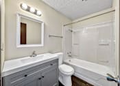 Thumbnail 9 of 20 - a bathroom with a sink toilet and a shower at Foxwood Apartments, Indianola Iowa  