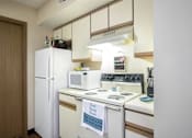 Thumbnail 3 of 24 - a kitchen with a stove microwave and refrigerator at Hunters Run Apartments, Newton, IA,  50208
