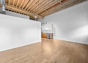 Thumbnail 61 of 99 - A room with wooden floors and a white wall.at Plant 1 Lofts, Iowa   
