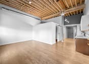 Thumbnail 60 of 99 - A room with wooden floors and a white wall.at Plant 1 Lofts, N. Newton, IA 50208  
