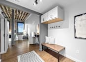 Thumbnail 3 of 99 - A room with a bench and a painting on the wall.at Plant 1 Lofts, Iowa, 50208